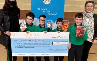 Wendy McKeown Principal Dromintee PS and pupils receive 2nd Prize of £500 from Kelly McKeown, Mulkerns SPAR / Eurospar